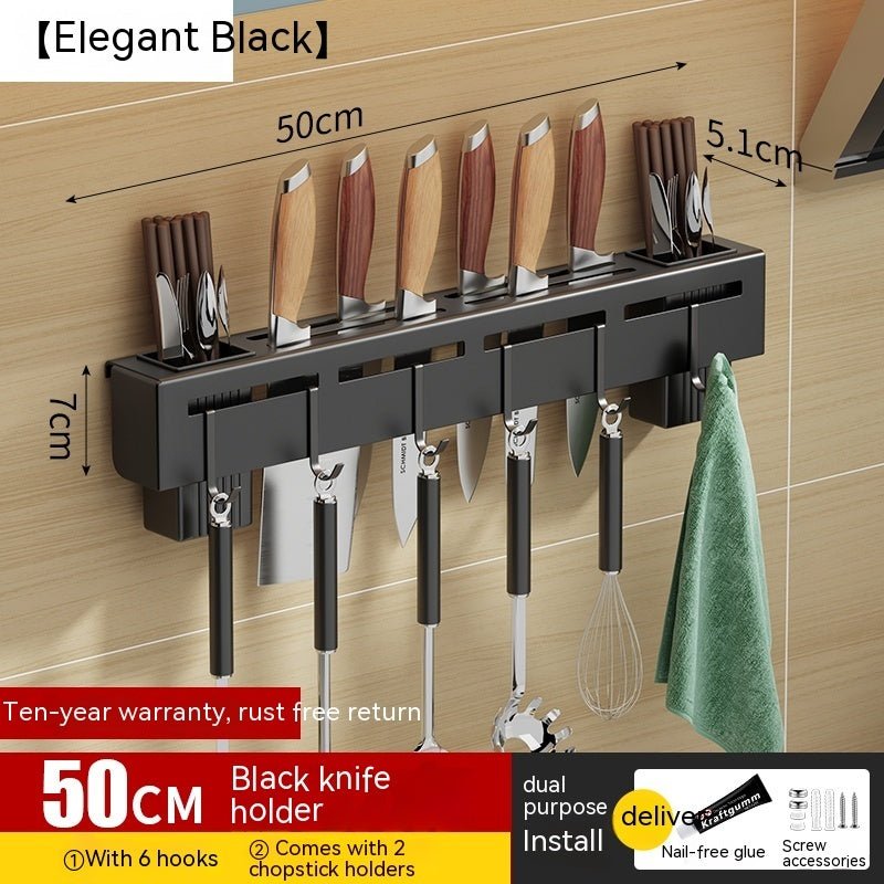 Black knife holder with hooks and chopstick holders on a wooden wall.