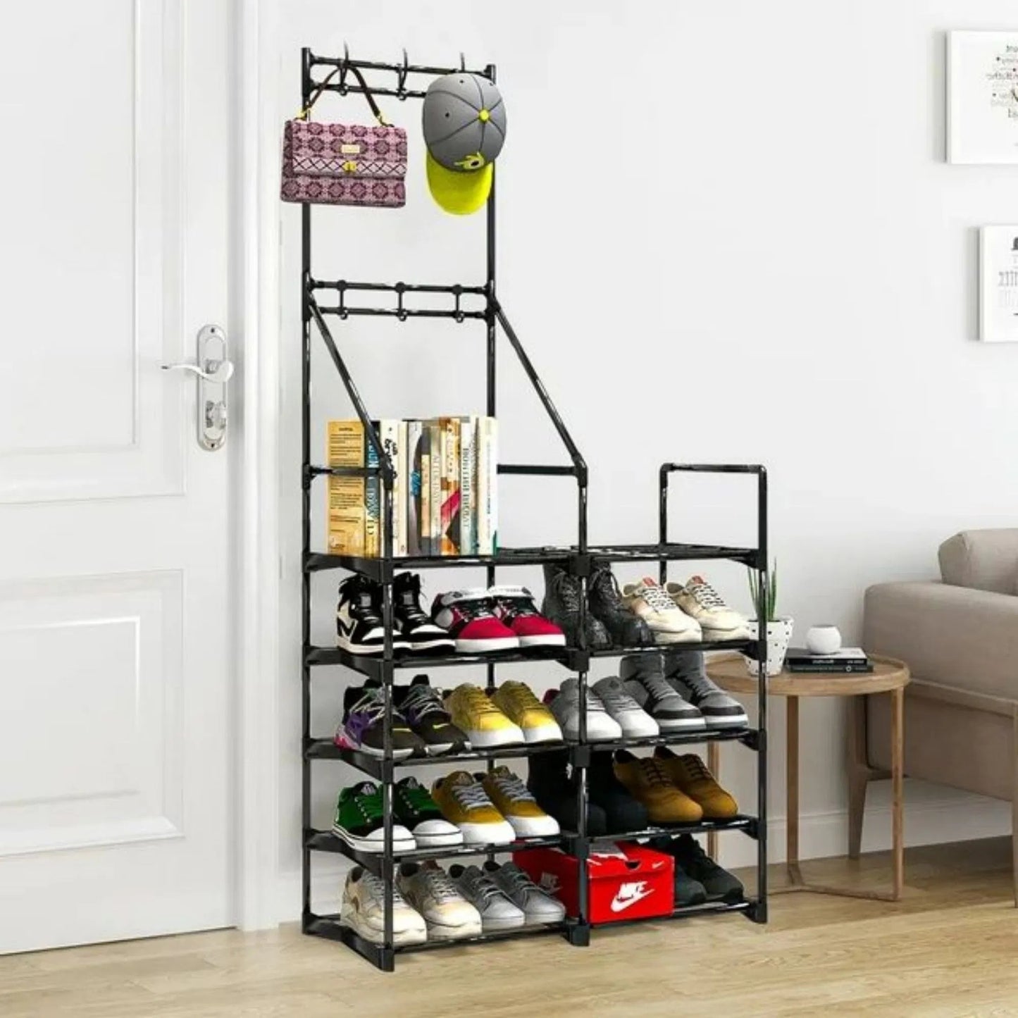 Black metal shoe rack with various shoes and a hat on a wooden floor.