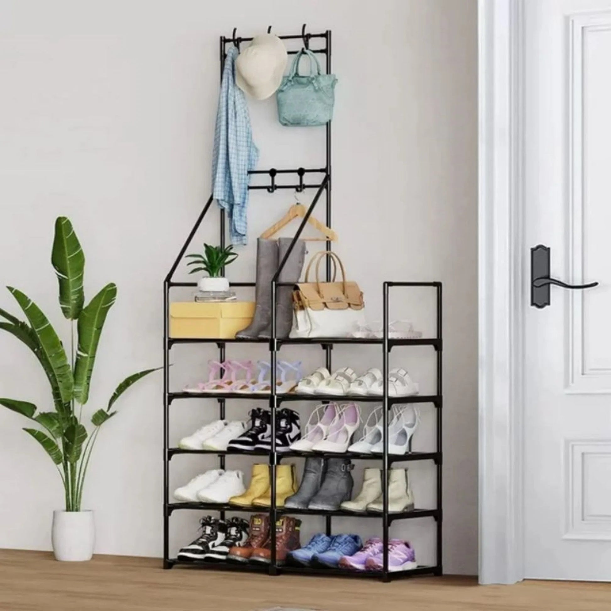Shoe rack with various shoes and bags on shelves in a room with a plant and door.
