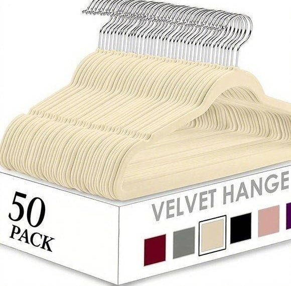 Box of 50-pack beige velvet hangers with metal hooks on a white background