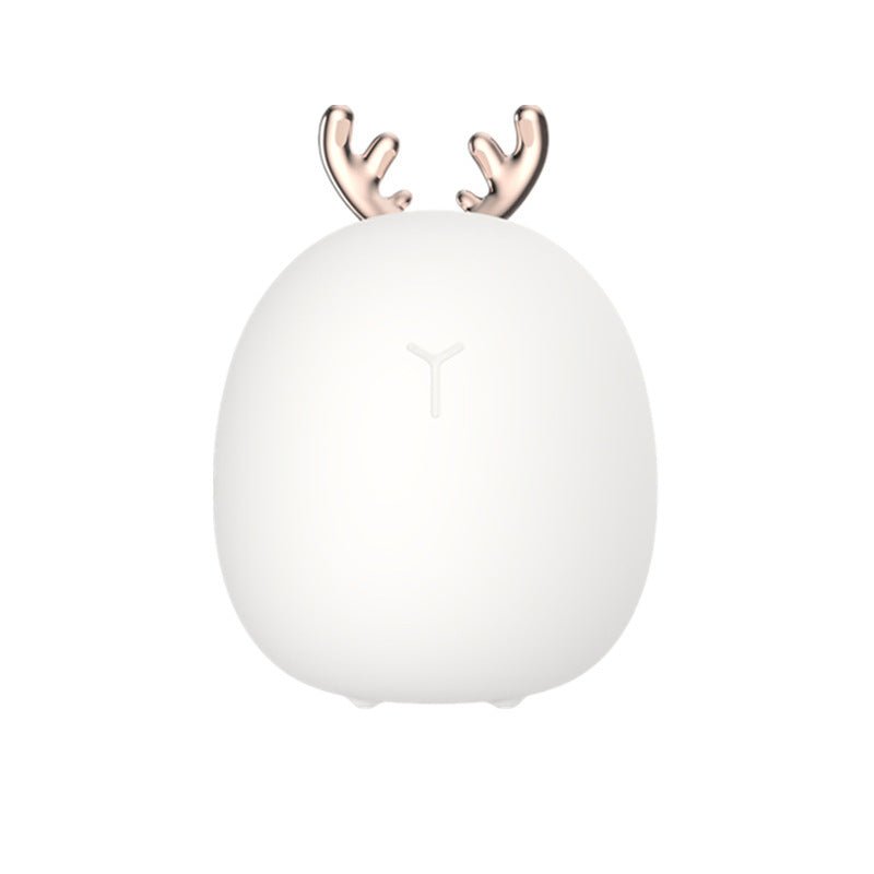 White spherical night light with gold antlers on a white background