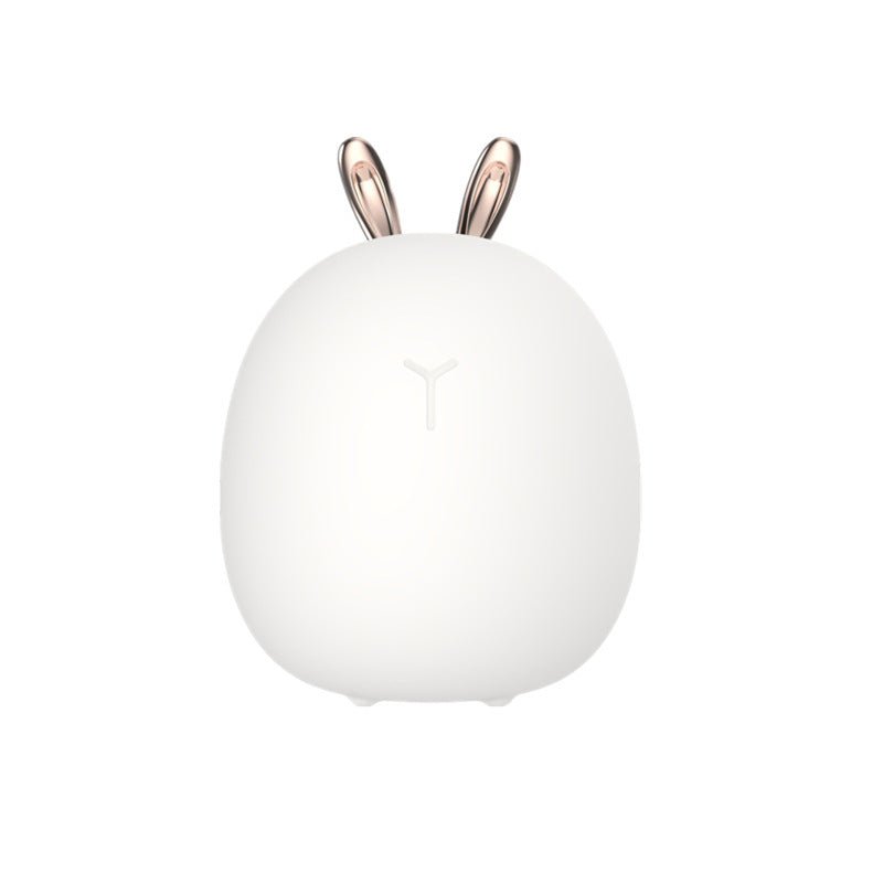 White spherical lamp with rose gold bunny ears on a white background