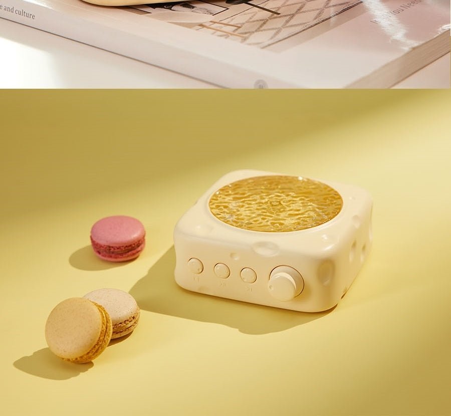 White square-shaped device with a textured surface, resembling a macaron, on a yellow background.