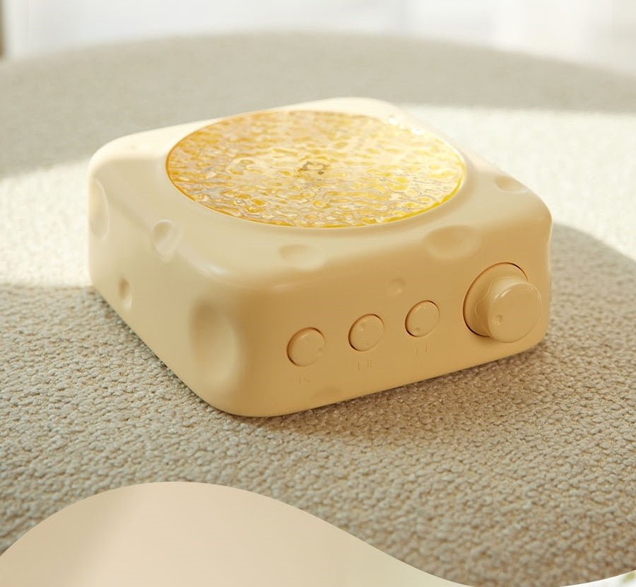 Beige square device with a textured yellow top on a textured surface