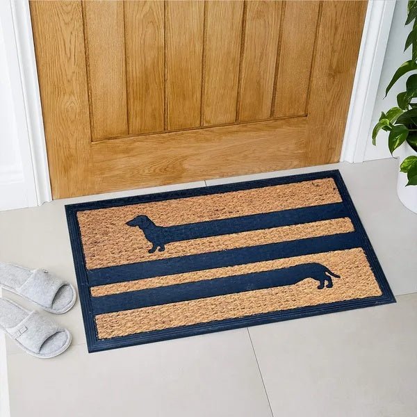 Doormat with dachshund design in front of a wooden door