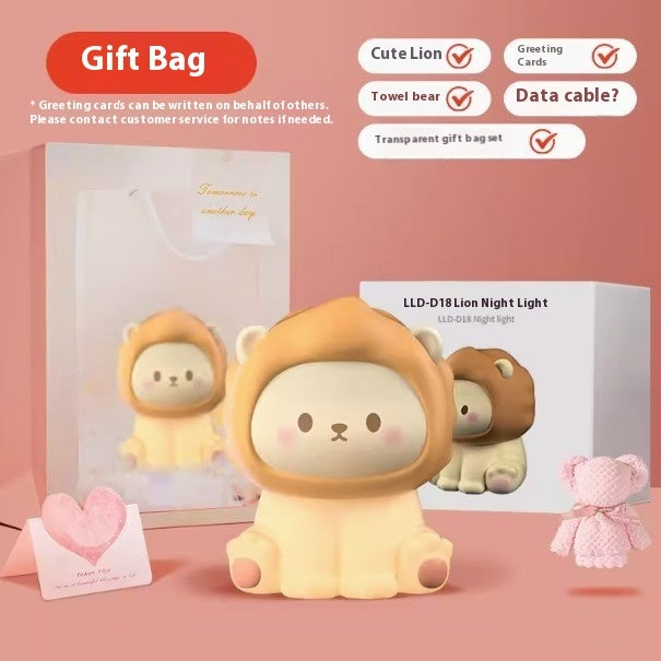 Cute lion-themed product with gift bag, cards, towel bear, and night light on a pink background.