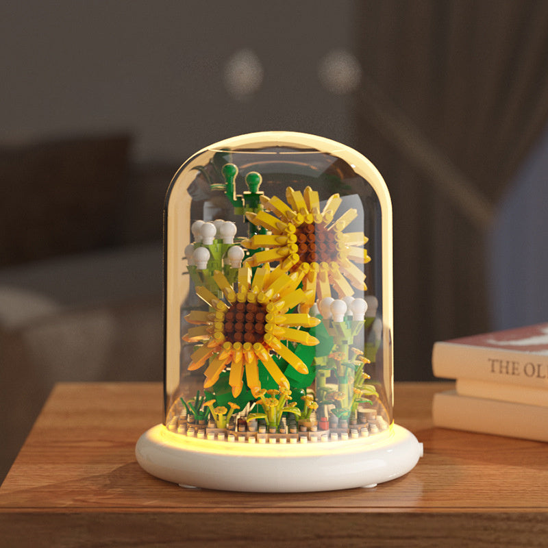 Decorative lamp with sunflower design on a wooden surface