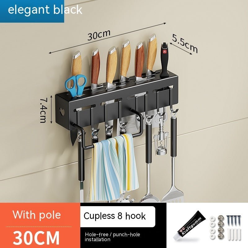 Wall-mounted kitchen organizer with hooks and measurements on a beige wall.