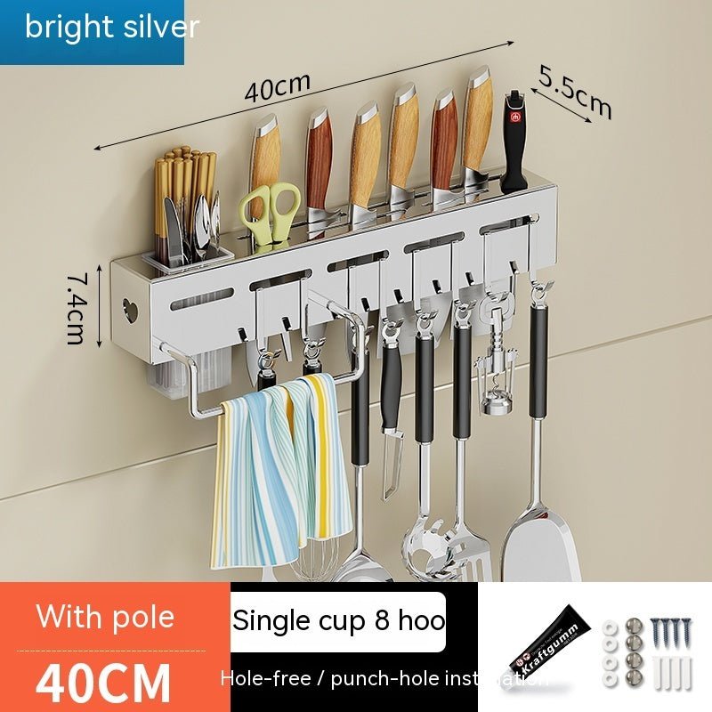 Wall-mounted kitchen organizer with hooks and measurements on a beige wall.