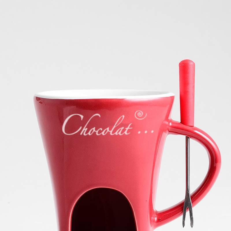 Red mug with 'Chocolat' text and a spoon holder on a light gray background