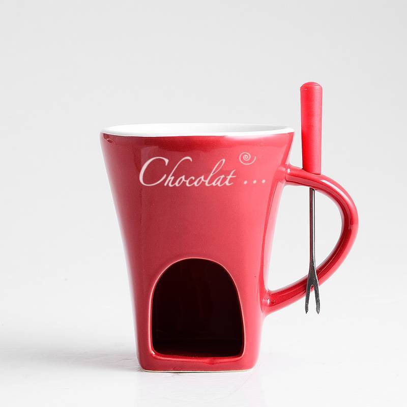 Red mug with a hole for a chocolate bar and a spoon, on a white background