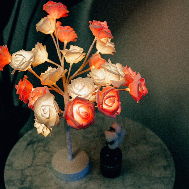 Decorative lamp with illuminated roses on a dark background