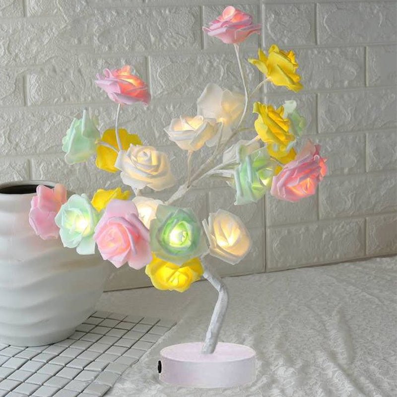 Decorative LED flower lamp with colorful flowers on a white brick wall background