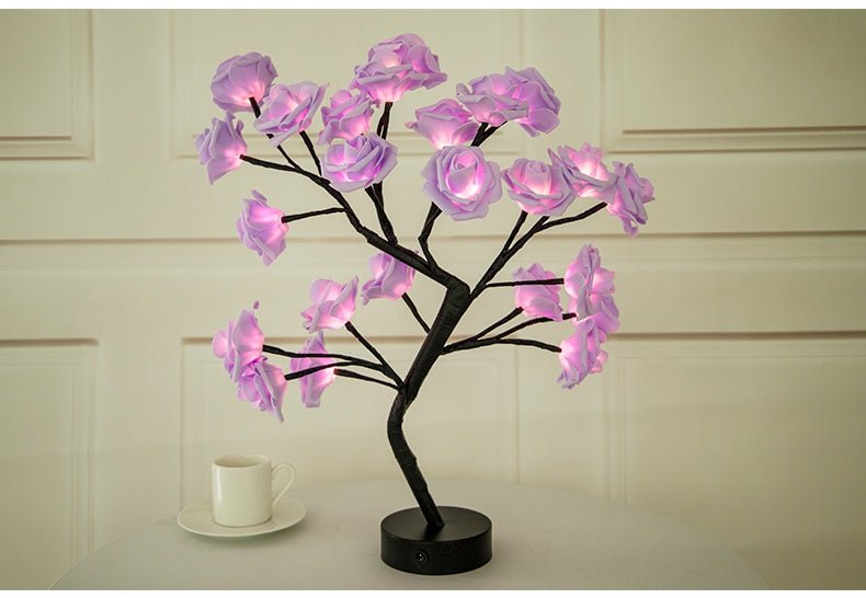 Decorative lamp with pink flower lights on a white surface.