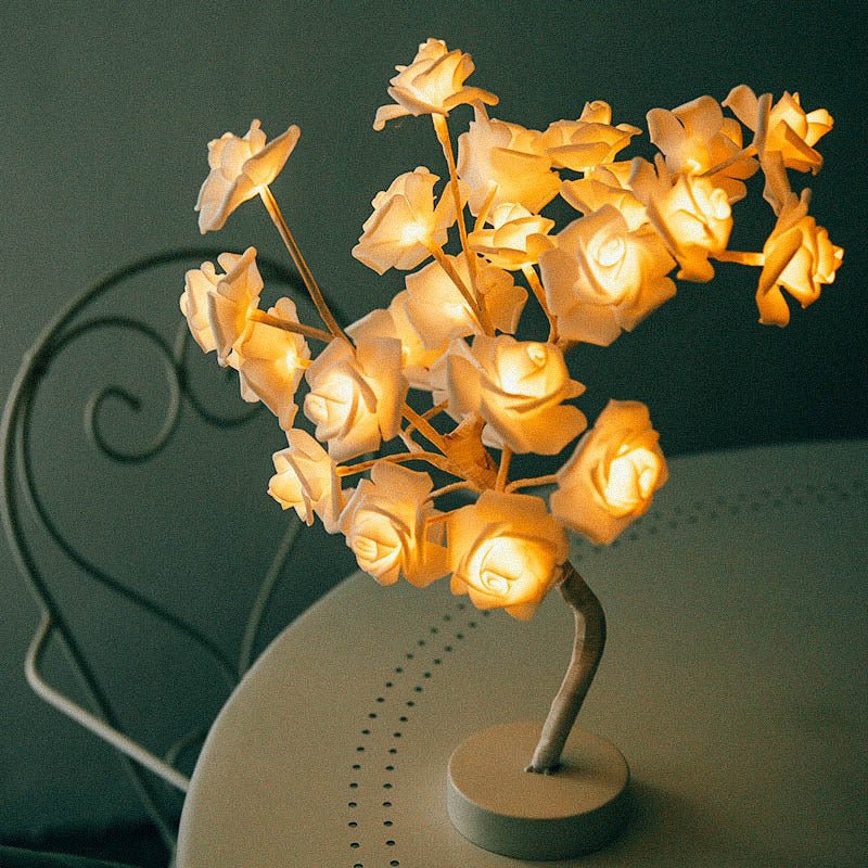 Decorative lamp with illuminated rose-shaped lights on a dark background