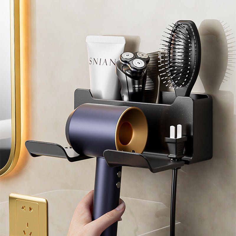 Bathroom wall organizer with hair dryer, brush, and other items on a light-colored wall.