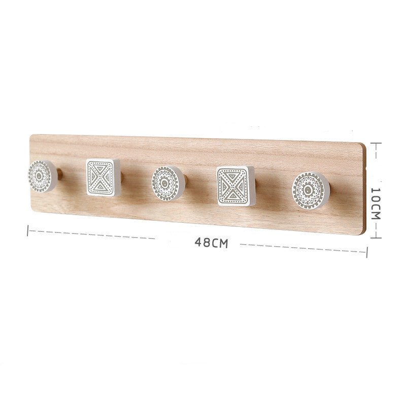Wooden wall hook with five decorative metal hooks and measurements on a white background