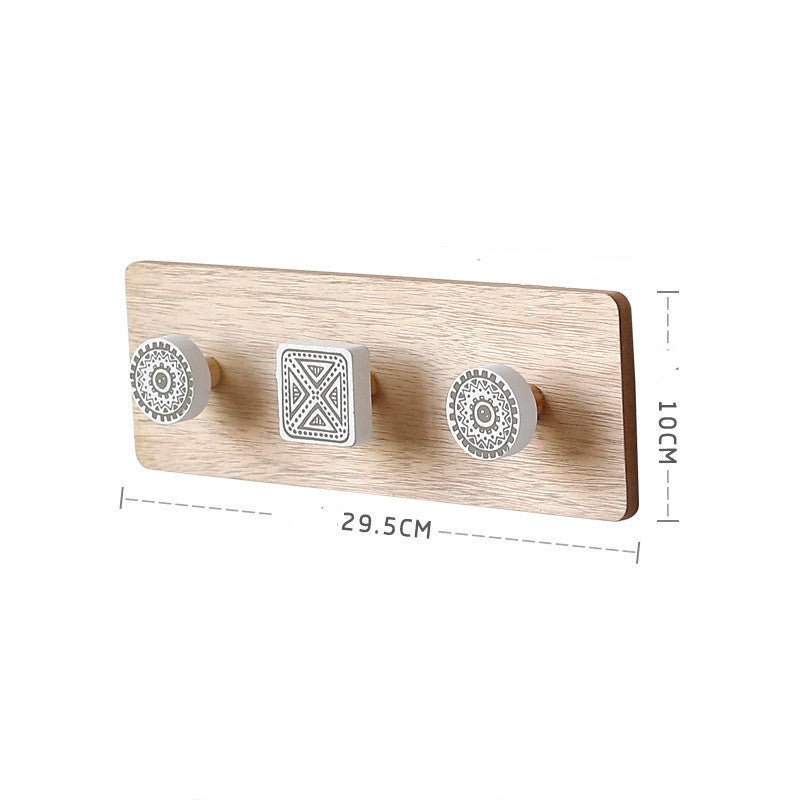 Wooden wall hook with three decorative hooks and measurements on a white background